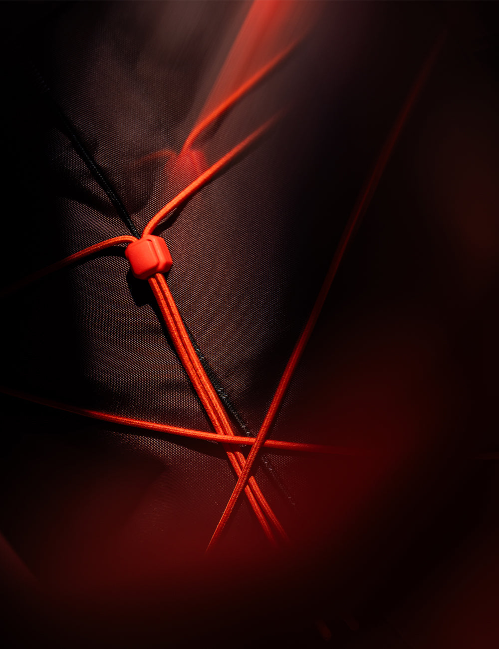close up of orange cord on garnet fabric