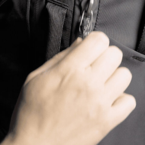GIF of hand smoothly unzipping a zipper