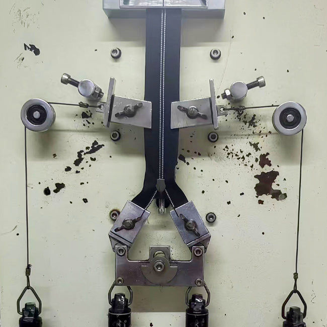 zipper being tested by factory machine