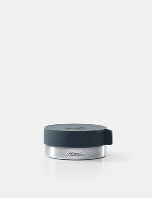 Silver container with a black lid on a white background