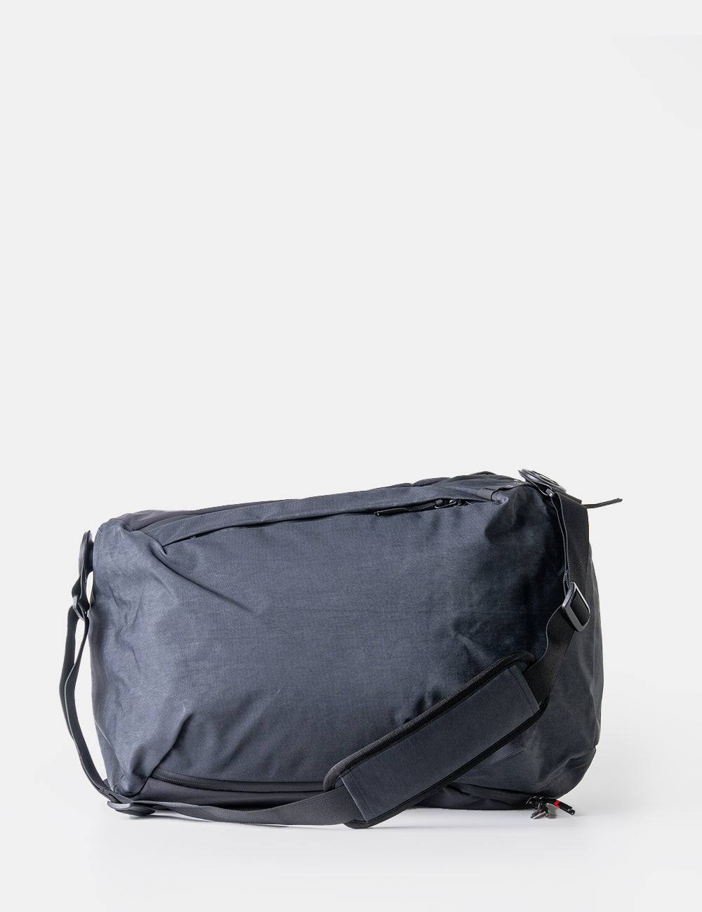 black backpack on side on white back ground
