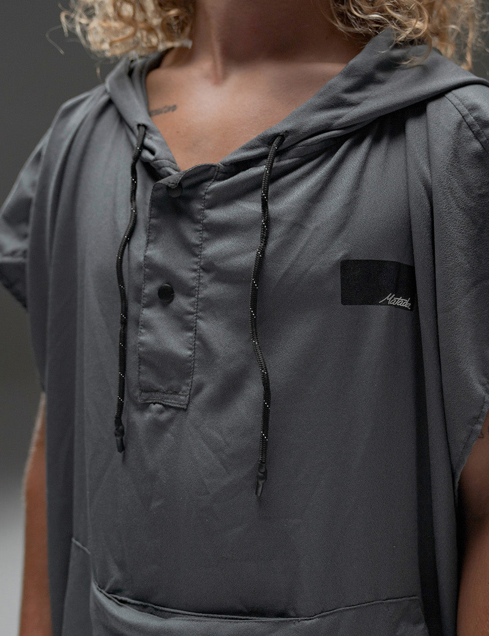 detail view of poncho snaps and drawstrings