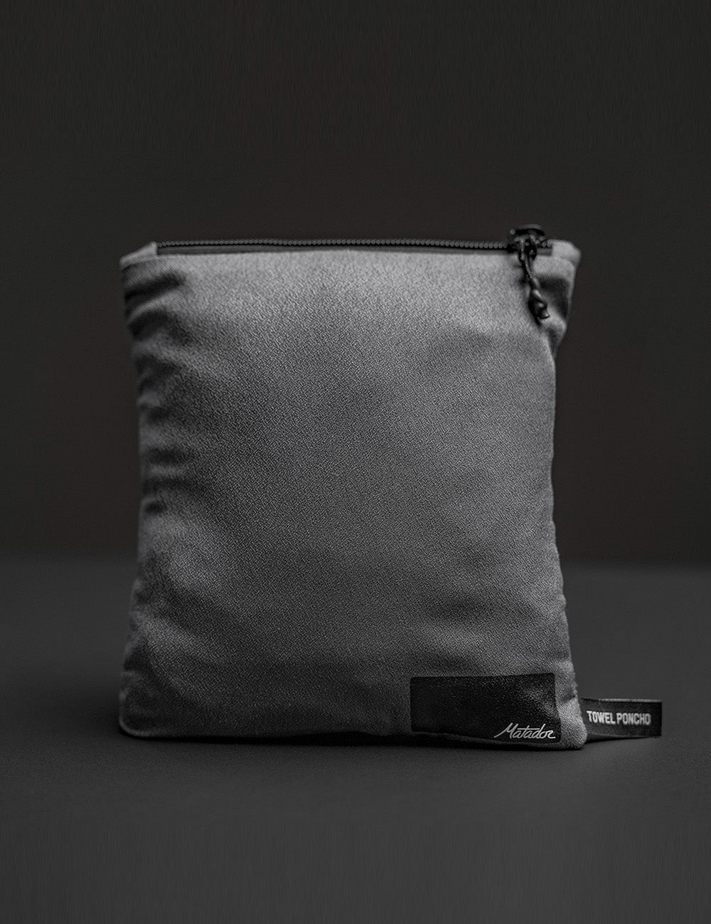 packed up poncho pouch on gray background
