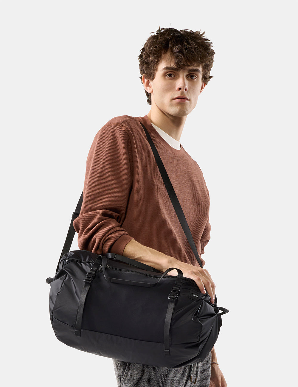 person with black duffel on white background
