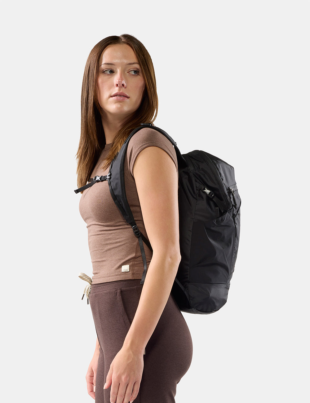 person wearing black backpack on white background