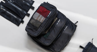 packing cubes and mesh bags on gray background