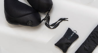 black travel pillow on white background