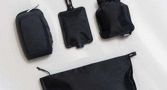 black toiletry products on light gray background