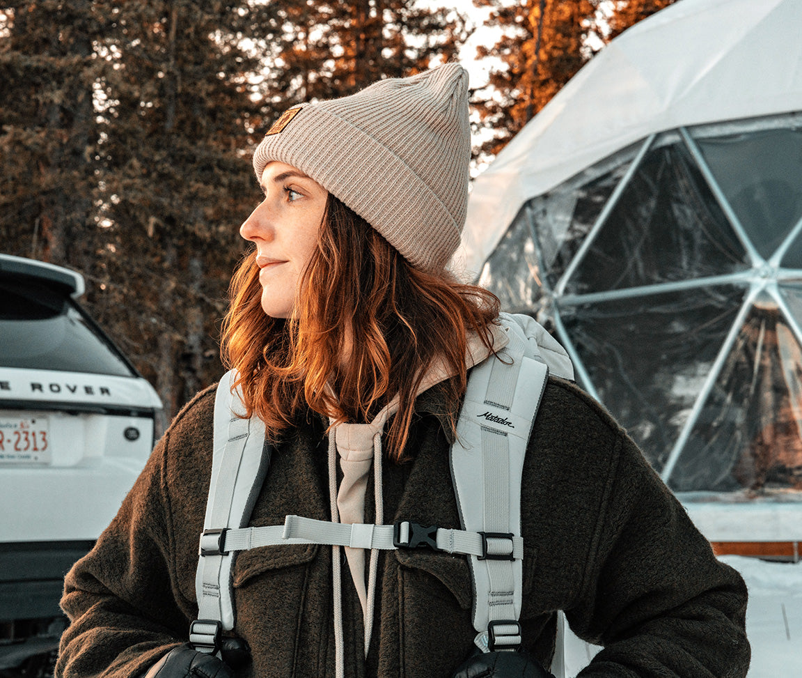 person wearing a travel bag at a dome tent in Canada