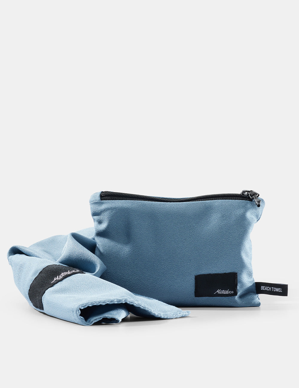 Light blue beach towel packed into a pouch with black zipper and matching fabric on a white background