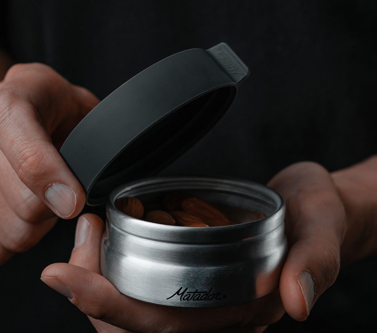An aluminum travel canister with a lid bering closed to pack for a trip